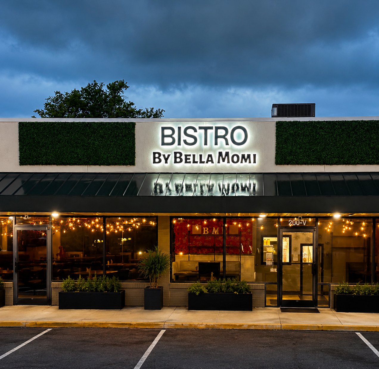 Bistro by Bella Momi storefront lit up at dusk on Oakwood Avenue